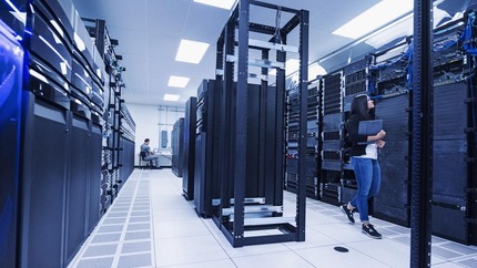 Interior photo showing rows of server racks in a data center