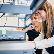 Researchers observe an experiment.